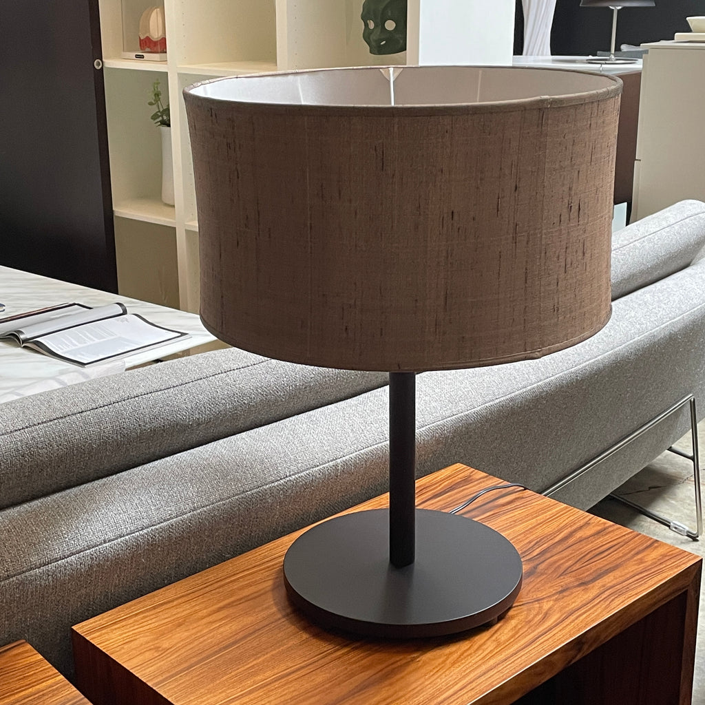 A Penta Wood Table Light with a brown shade on top.