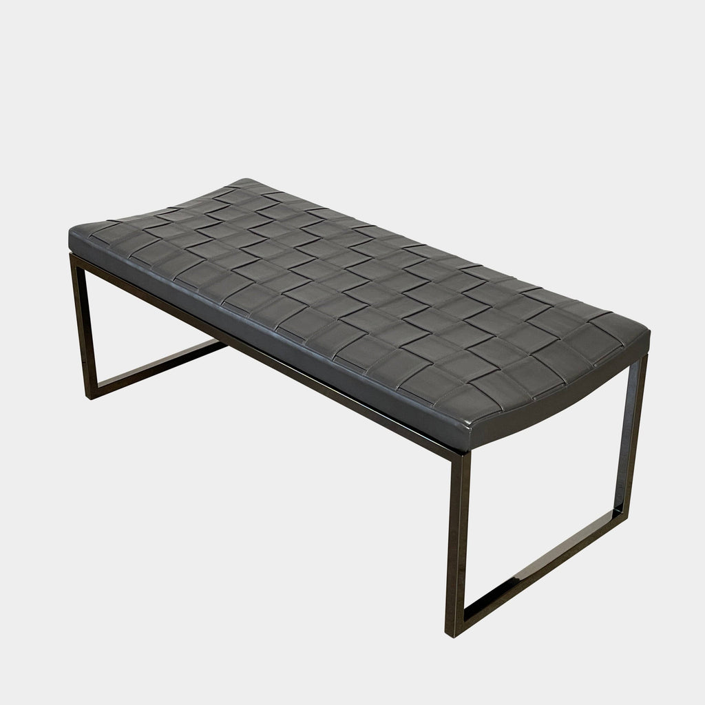 Minotti Monge bench with a metal base against a white background.