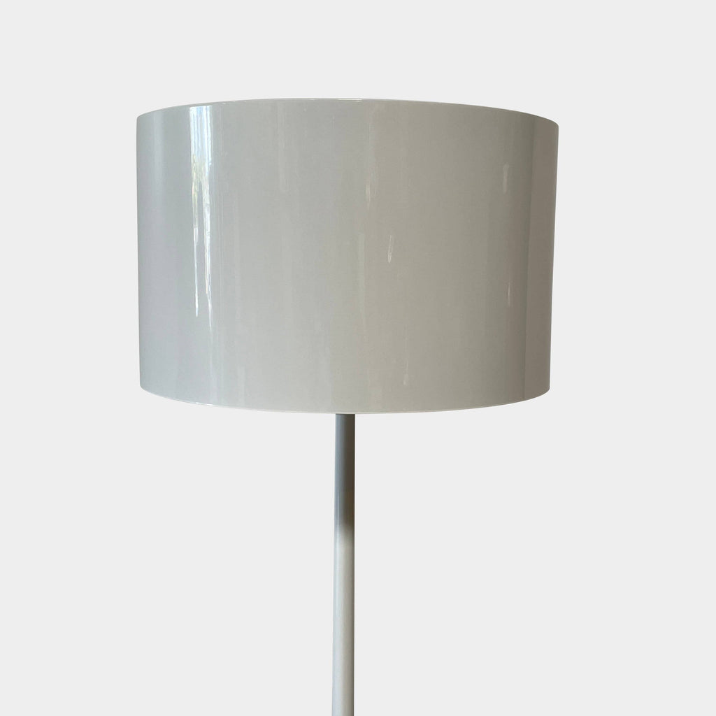 A modern Flos Spun Floor Light with a spun aluminum frame and a white base and shade.
