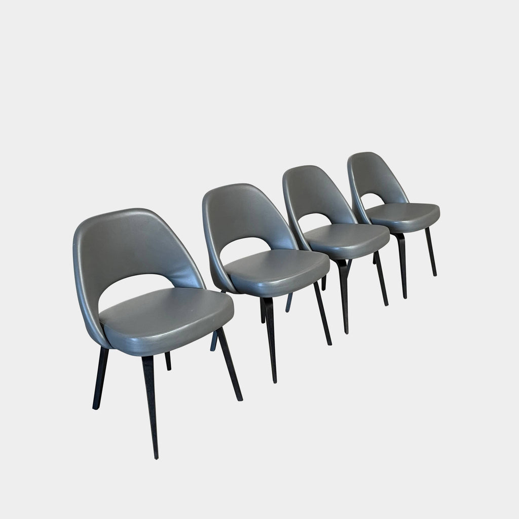 Four identical black Knoll Saarinen Executive Dining Chair Sets in a row against a white background.