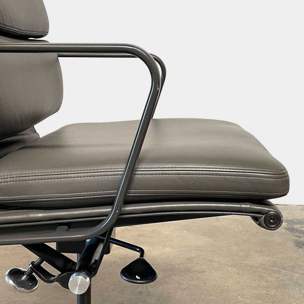 Adjustable Eames Management Soft Pad office chair with black casters and blue upholstery.