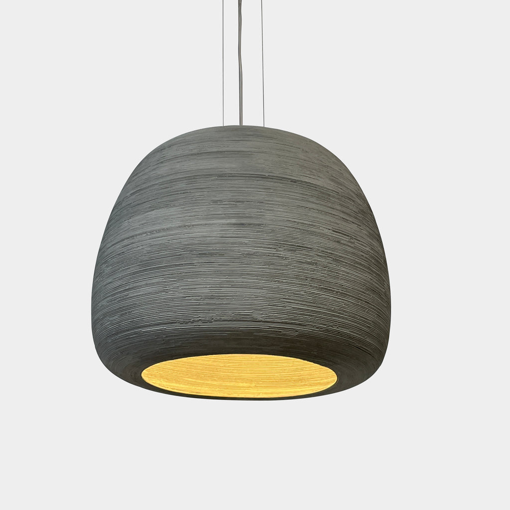 A Ceramic Hanging Pendant Light Moooi by Foundry hanging from a white wall.