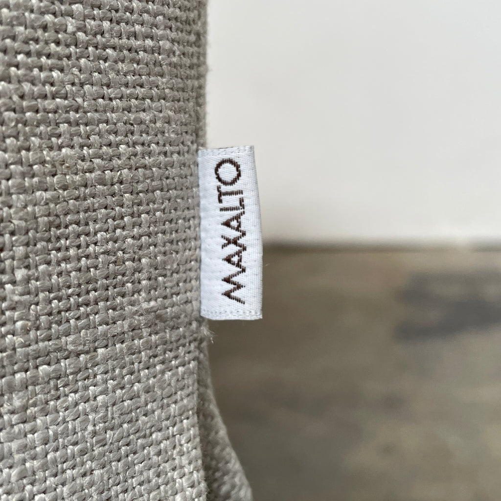 Close-up of a textured Maxalto Agathos Swivel Lounge Chairs fabric with a visible seam.
