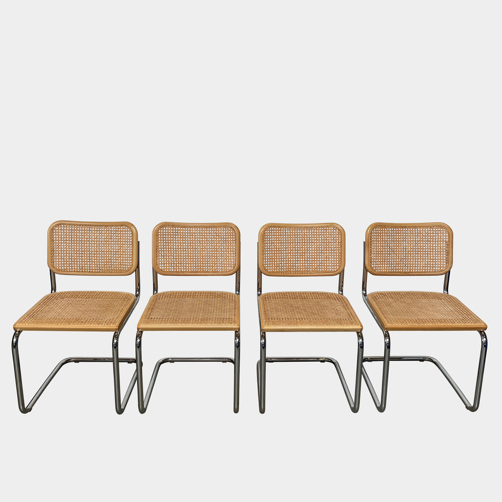 Four vintage Knoll Cesca dining chairs with wicker seats and backs, arranged in a row on a white background.