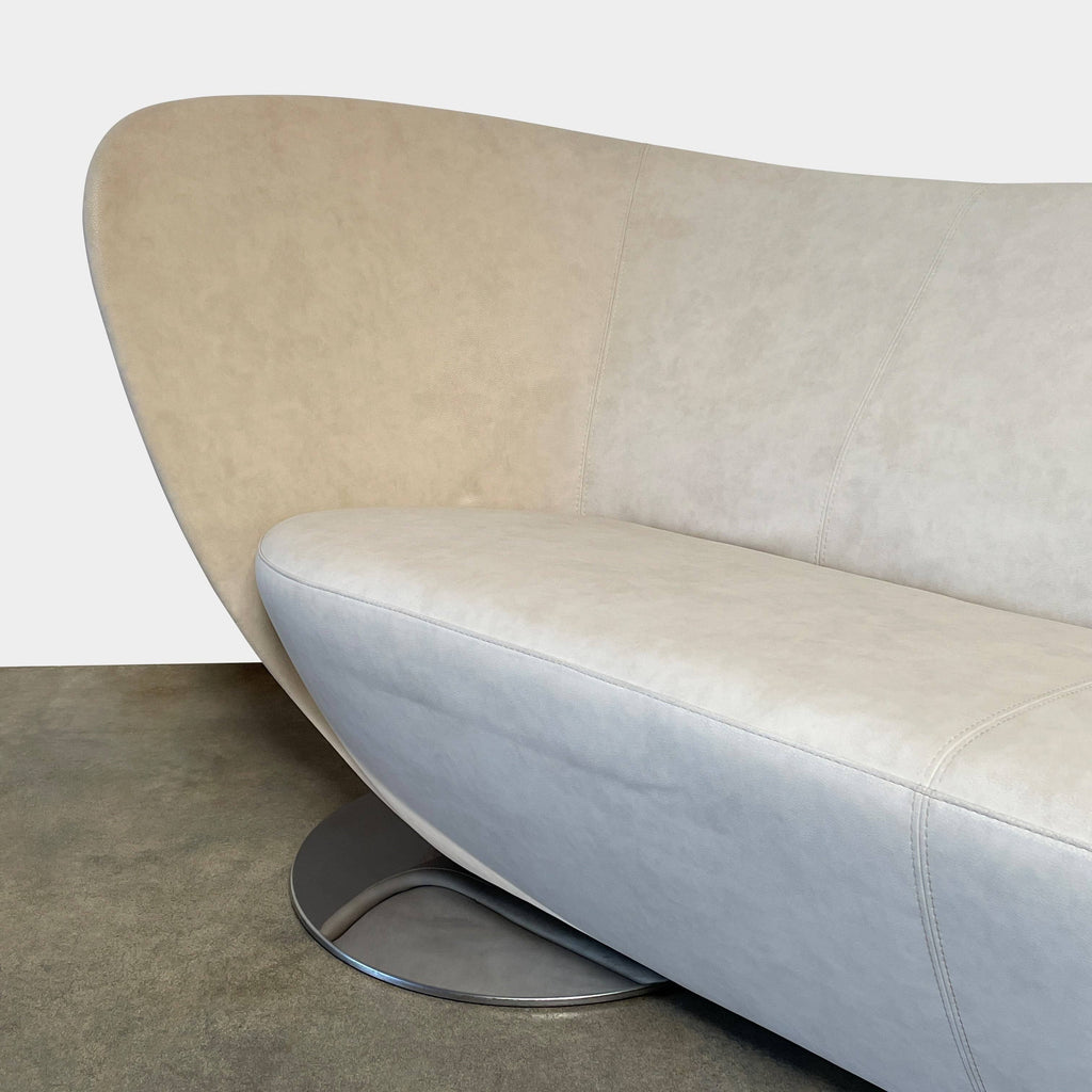 Modern curved La Cividina Mon Coeur sofa isolated on a white background.