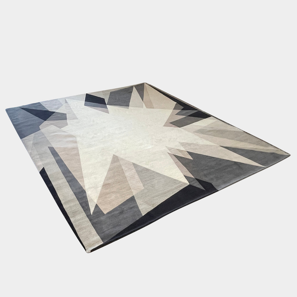 A dramatic black The Rug Company Alma Rug with geometric shapes on a white background.