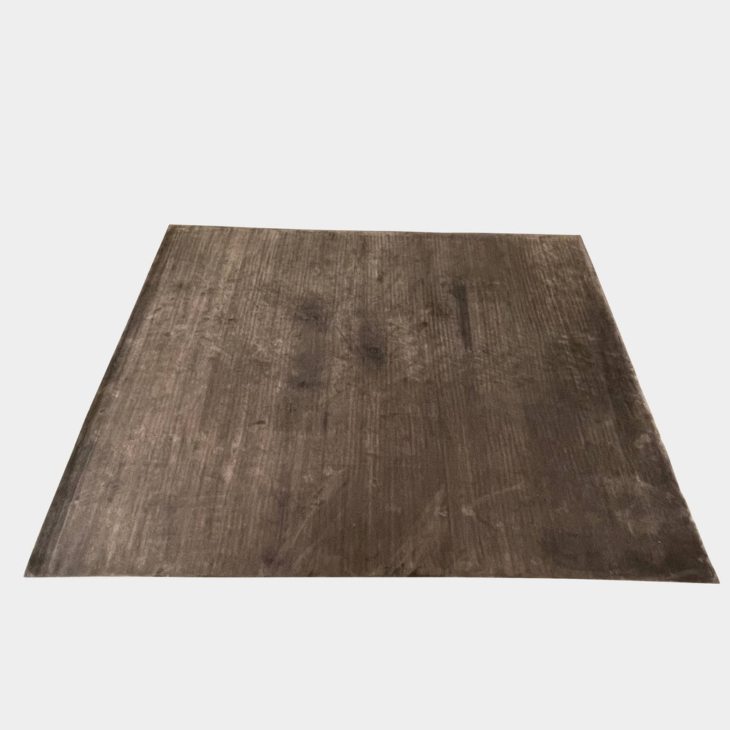 An image of a grey wooden floor with a Delinear Bamboo Charcoal 8' X 10' Rug.