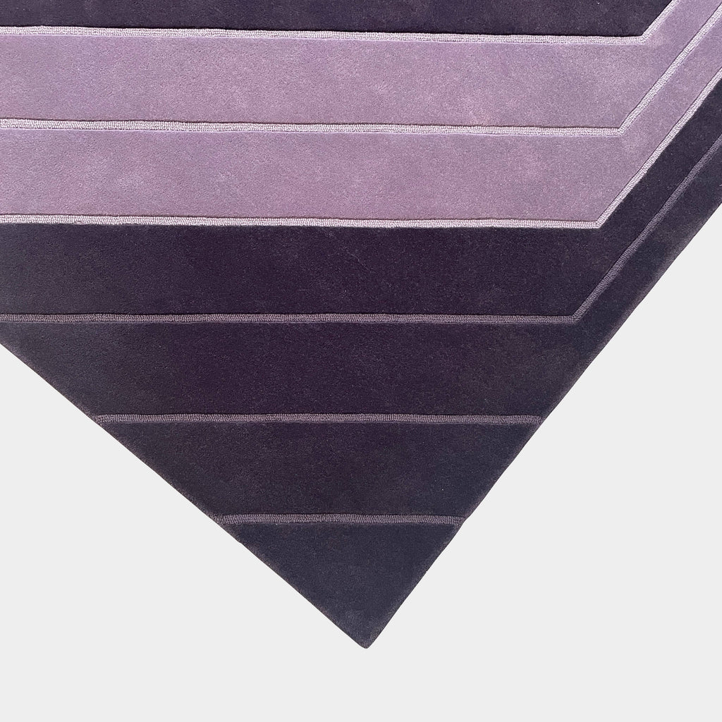 A Della Robbia Jay-V Custom Rug with purple and black stripes on it.