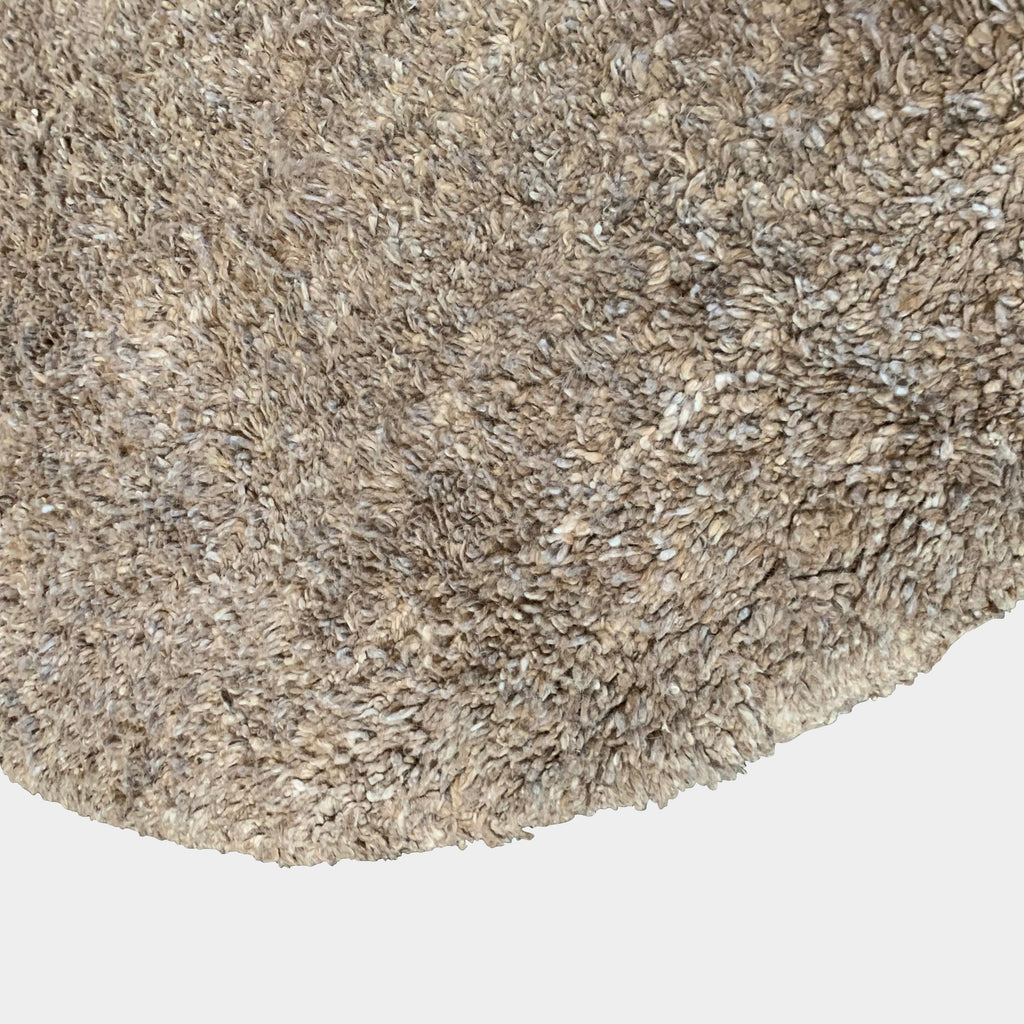 A Delinear Anemone Round Shag Rug on a white background, featuring a taupe color palette.