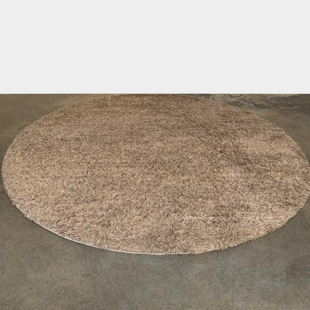 A Delinear Anemone Round Shag Rug on a white background, featuring a taupe color palette.