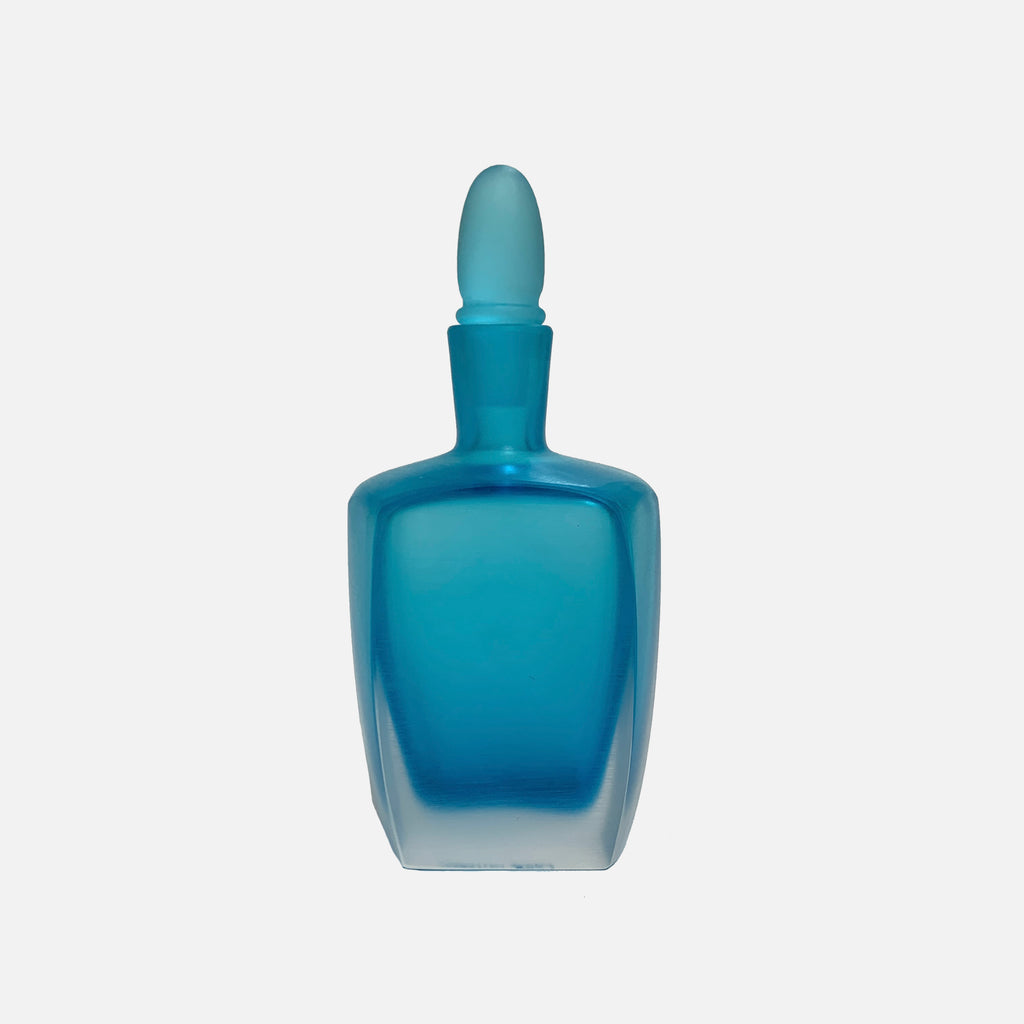 A blue glass Venini Bottiglie Incise Ocean bottle with cold-glass etching on a white background.