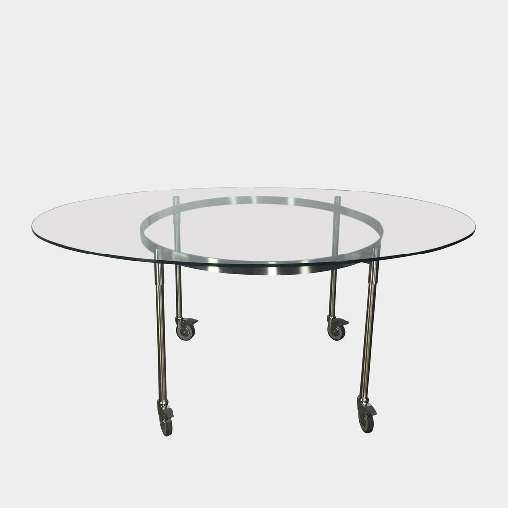 The Driade Ito Dining Table from Driade offers adaptability with its mobile design on wheels, making it easy to move around. It features a chrome base for a sleek and modern look.