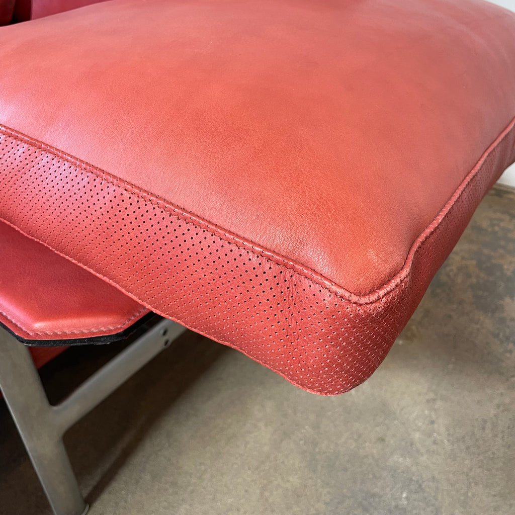 A B&B Italia Diesis red leather chaise lounge on a metal frame.