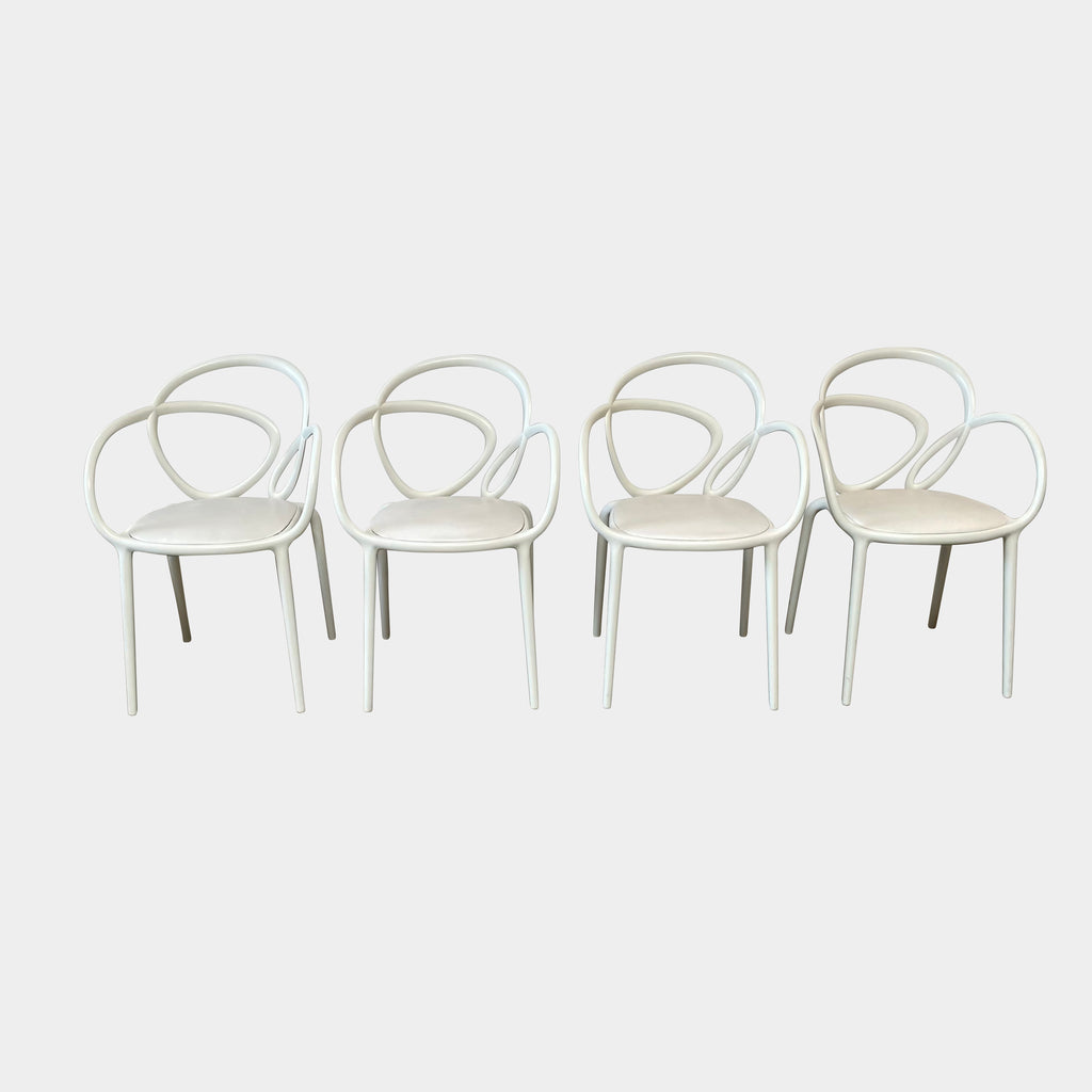 Four Qeeboo Loop Armchair Sets in a row against a white background.
