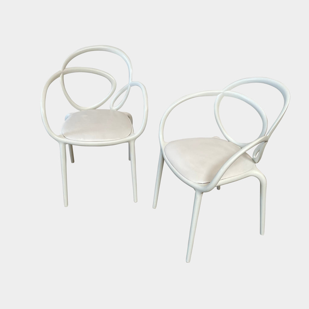 Four Qeeboo Loop Armchair Sets in a row against a white background.