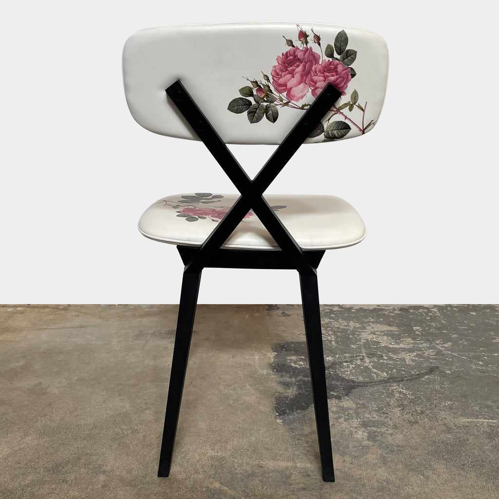 A set of six Qeeboo Chair X dining chairs with a floral pattern.