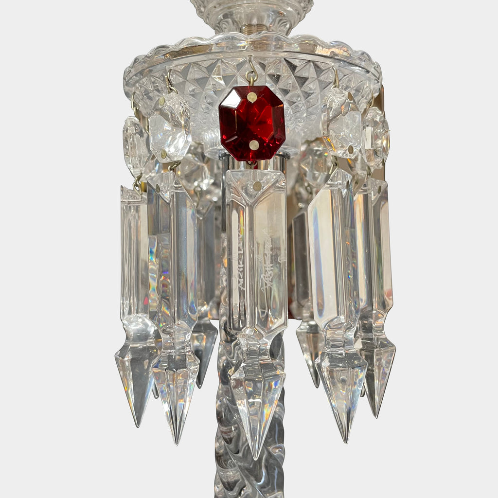 A Baccarat Torch Wall Sconce with a red tassel hanging from it.