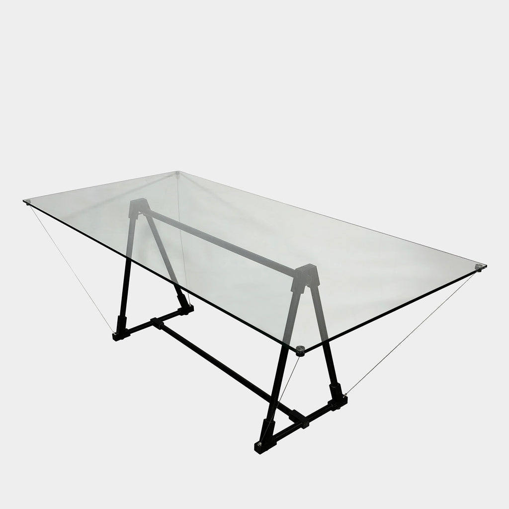 A Fontana Arte Multi-Functional table with a glass top and black legs.