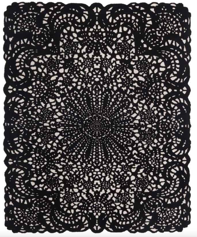 A Delinear Doily 8' X 10' Wool Rug with an ornate design.