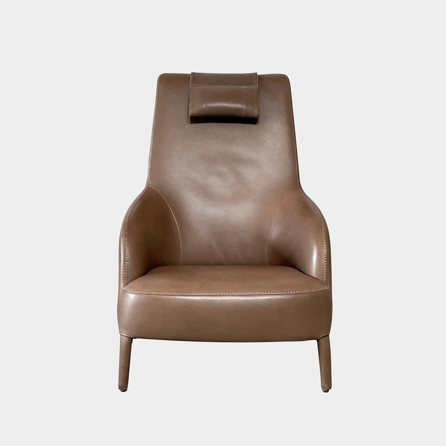 A brown leather armchair with a high backrest and curved arms, showcasing classic leather upholstery, is paired with a matching ottoman, both resting on thin legs. This sophisticated set embodies the elegant style of Maxalto's Maxalto Febo High Back Lounge Chair and Ottoman collection.