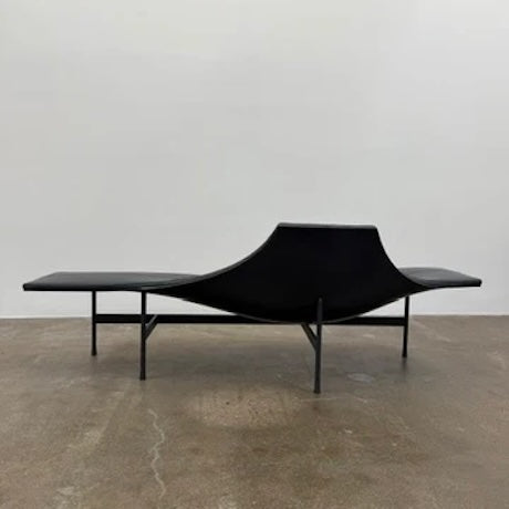 The B&B Italia Terminal 1 Lounge is a modern black bench with Jean-Marie Massaud’s sculpted, wave-like seat, a raised central backrest, and a minimalist black metal frame by B&B Italia.
