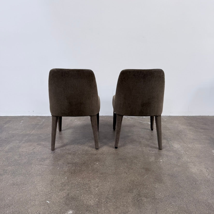 Two dark gray Maxalto Febo dining chairs with backrests, leather upholstery, and four tapered legs.