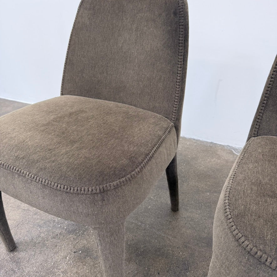Two dark gray Maxalto Febo dining chairs with backrests, leather upholstery, and four tapered legs.