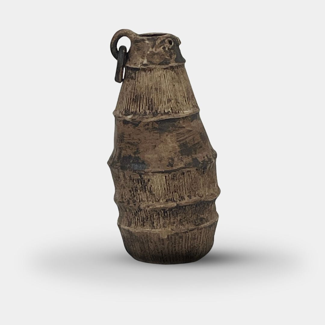 The Sofi Ceramic Bali Vase Long by Sofi Ceramics stands upright on a white background, showcasing rustic elegance with its textured finish and handcrafted vessel design, reminiscent of sculptured pieces.