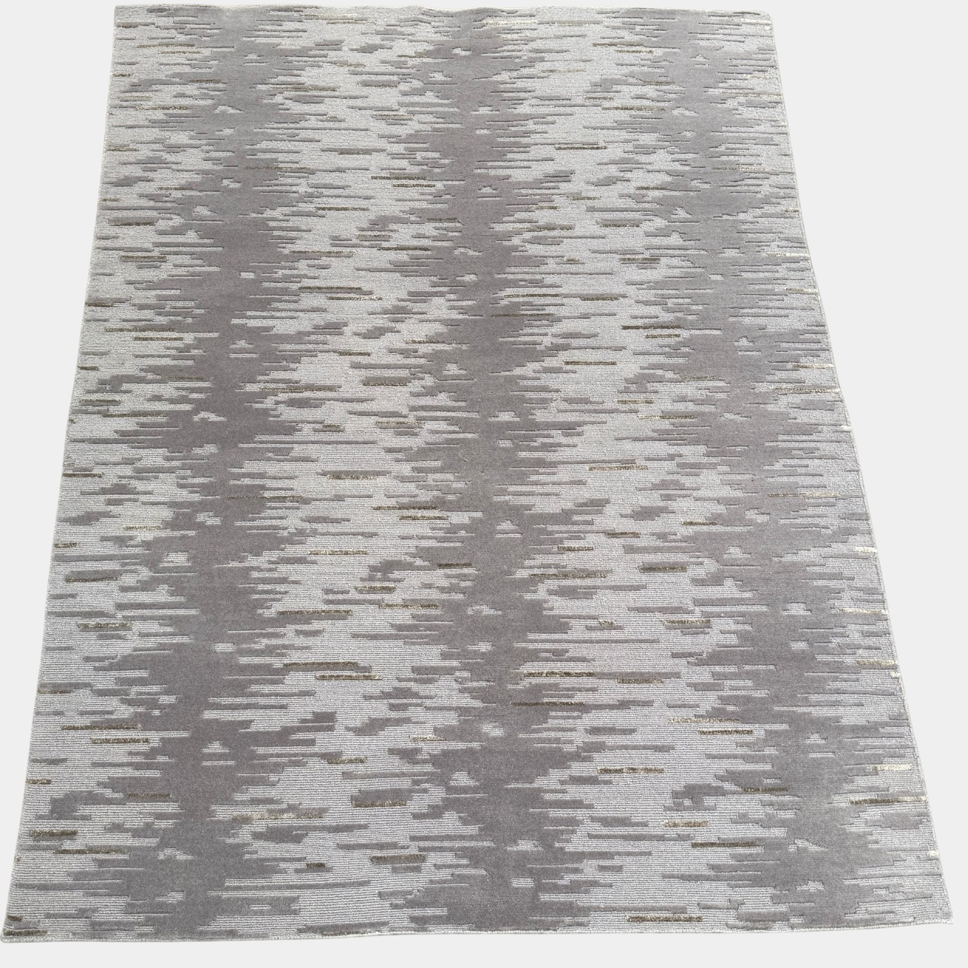A close-up of the Kvadrat Multi-pile Wool and Silk Rug by Kvadrat, featuring an abstract linear pattern in light and dark gray wool and silk, displayed on a white background.