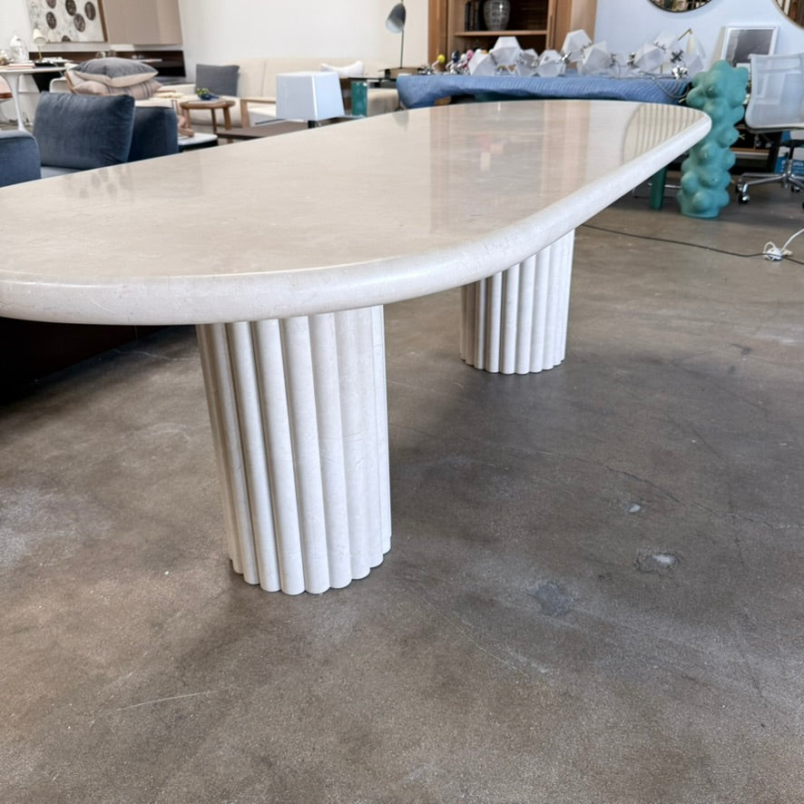 Form LA Fluta Oval Dining Table in Crema Marfil with a smooth top and two fluted cylindrical pedestals inspired by Roman architecture.