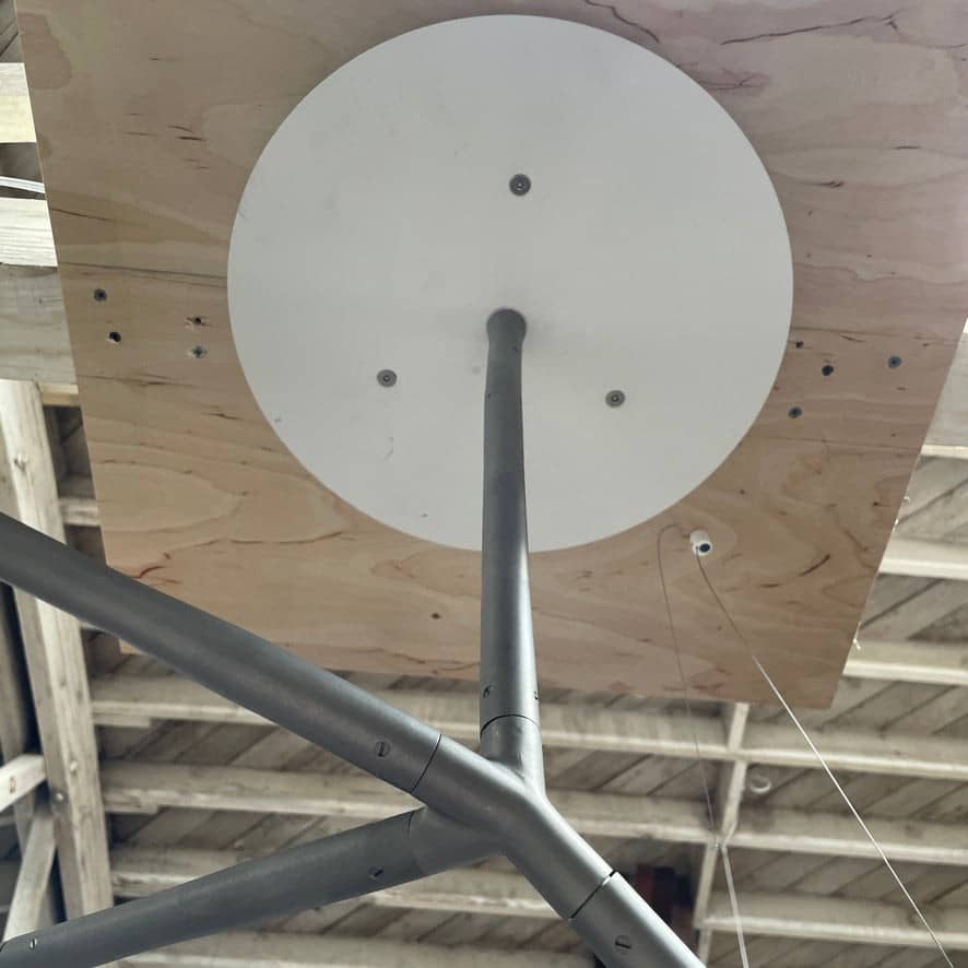 The Bocci Armature Chandelier T16.17aA1 by Bocci features multiple black branches with round, illuminated bulbs extending from a central base, offering a modern ceiling light fixture design inspired by contemporary aesthetics.