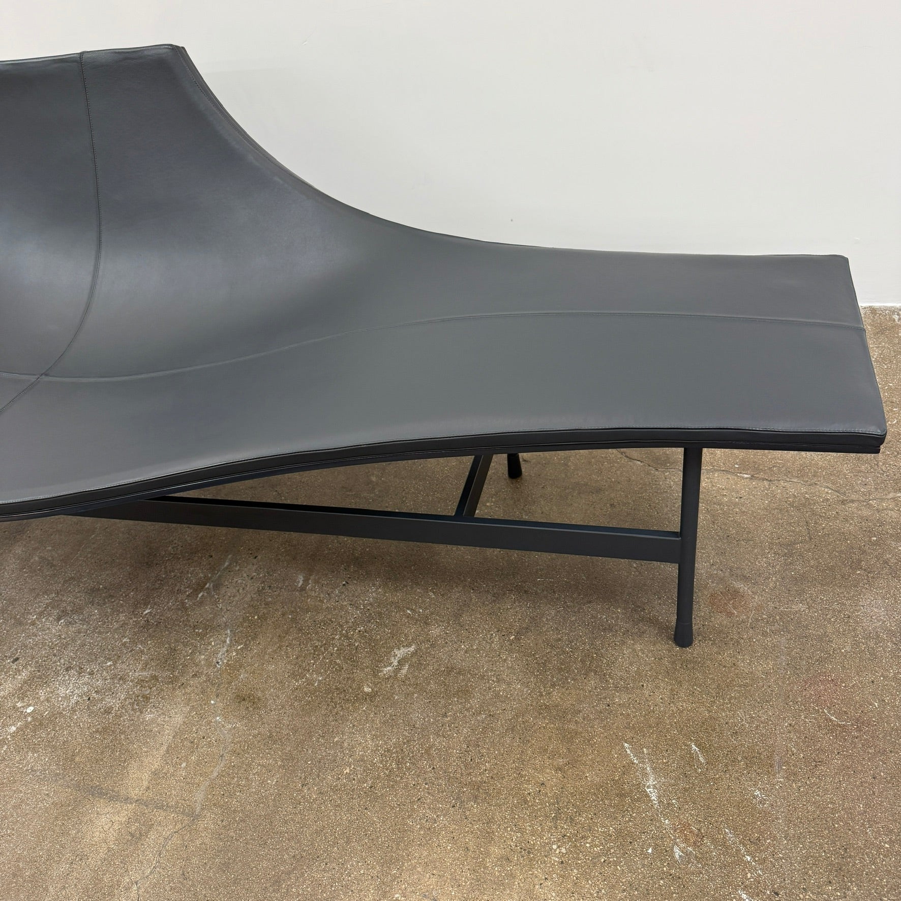 The B&B Italia Terminal 1 Lounge is a modern black bench with Jean-Marie Massaud’s sculpted, wave-like seat, a raised central backrest, and a minimalist black metal frame by B&B Italia.