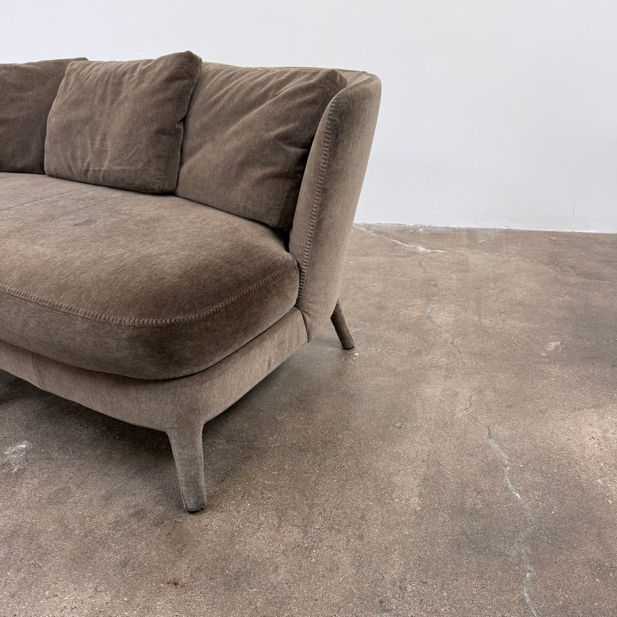 Small gray Maxalto Febo Small Sofa with a curved back, three back cushions, and visible stitched seams.
