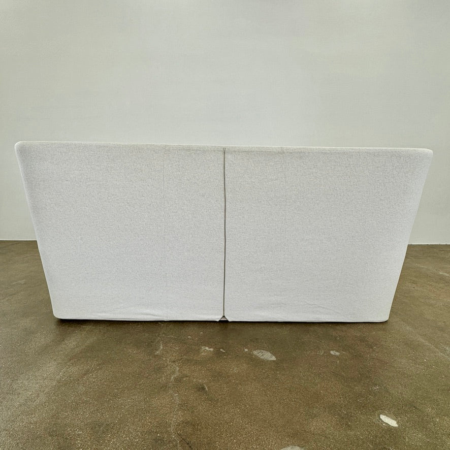 The B&B Italia Papilio King Bed by B&B Italia features a modern upholstered frame, cushioned headboard, and exposed wooden slats—ideal for contemporary bedrooms. Shown on a white background.