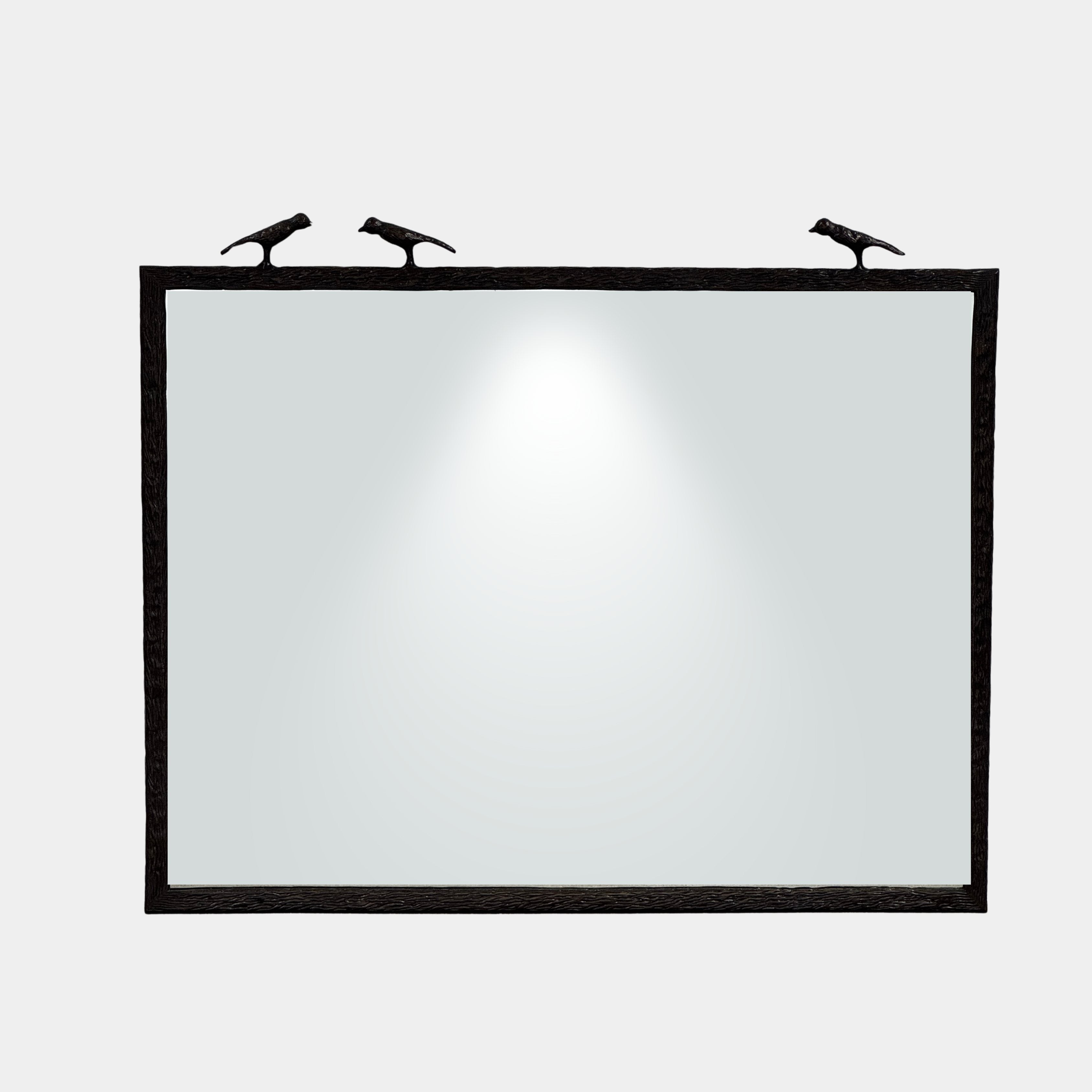 The Made Goods Joelle Three Birds Mirror is a rectangular wall mirror with a dark frame and three bird-shaped accents on its top edge, shown against a plain light background.