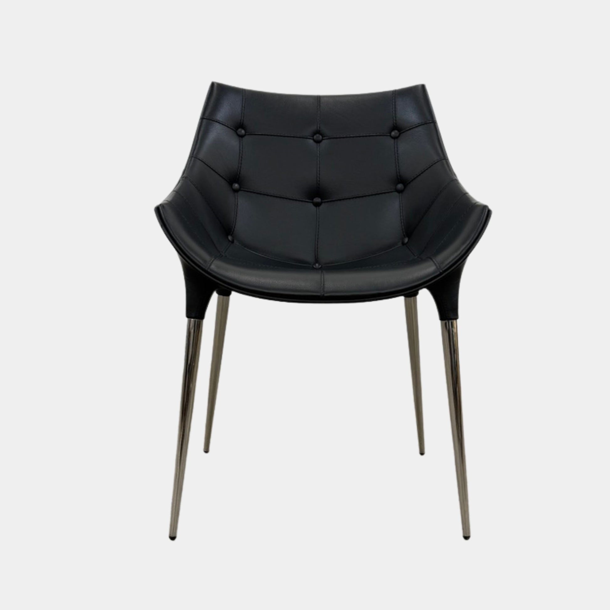 The Cassina Passion Side Chair by Cassina is a modern black upholstered chair with a curved backrest, button detailing, and four sleek metal legs inspired by the Passion design.
