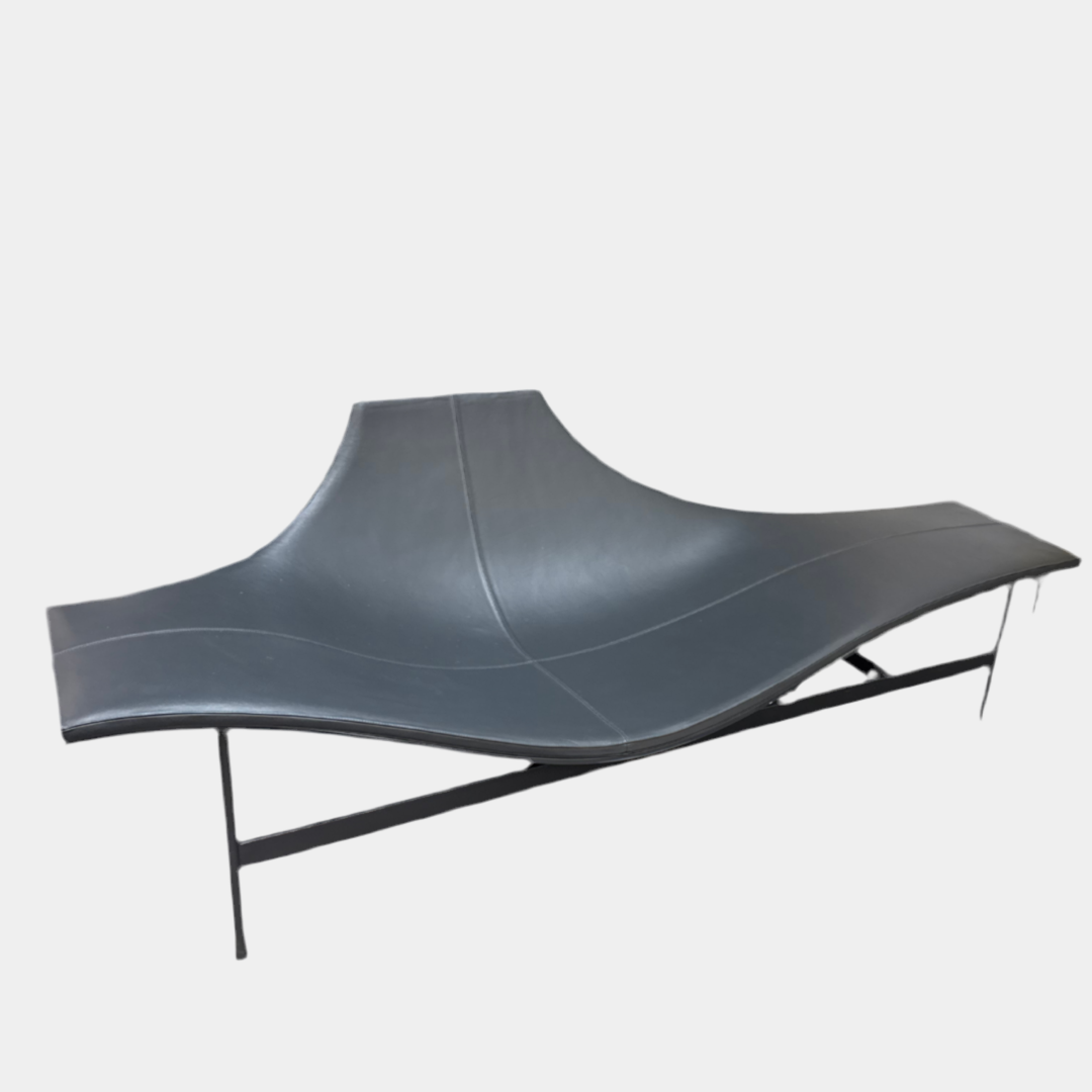 The B&B Italia Terminal 1 Lounge is a modern black bench with Jean-Marie Massaud’s sculpted, wave-like seat, a raised central backrest, and a minimalist black metal frame by B&B Italia.