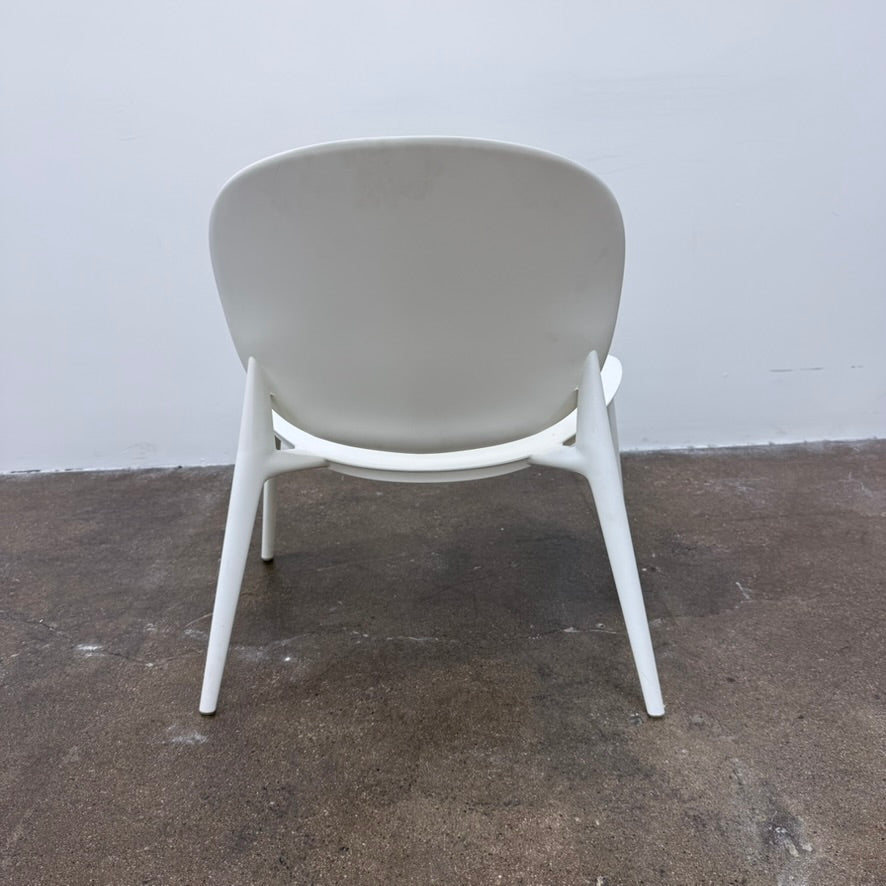 White Kartell Be Bop Lounge Chair with a rounded backrest and tapered legs, suitable for indoor and outdoor seating.