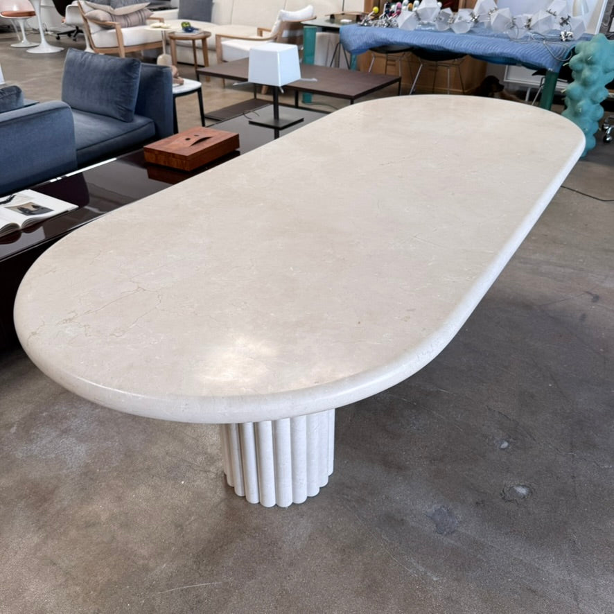 Form LA Fluta Oval Dining Table in Crema Marfil with a smooth top and two fluted cylindrical pedestals inspired by Roman architecture.