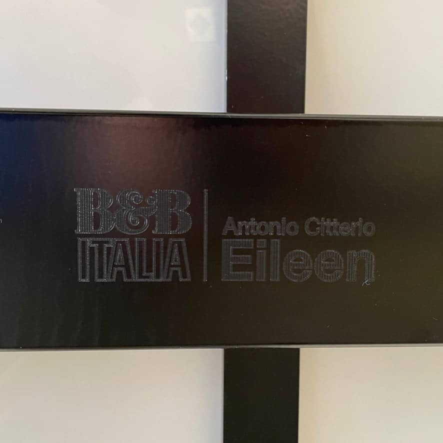 A minimalist rectangular B&B Italia Eileen White Dining Table featuring a sophisticated T-shaped metal base on a plain white background.