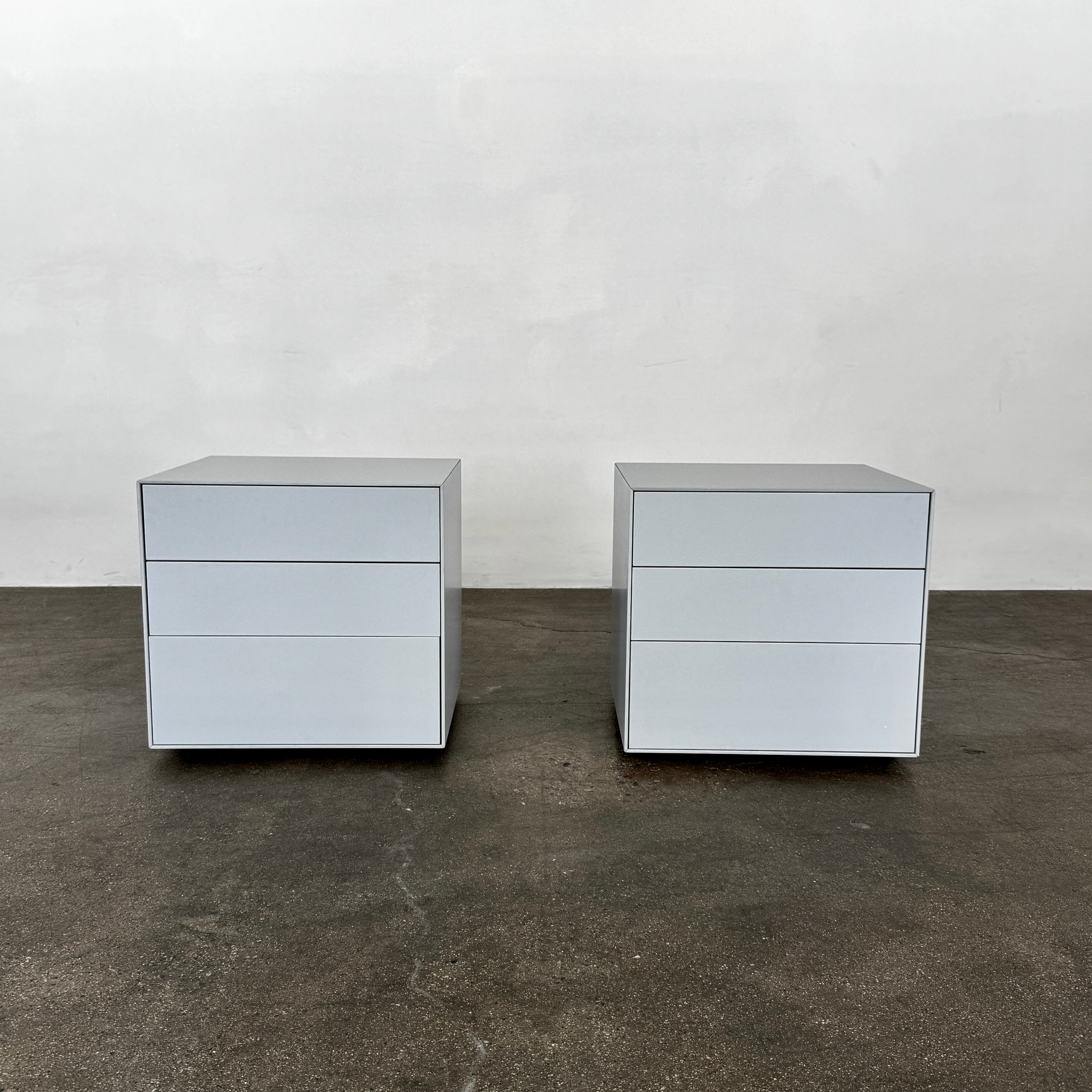 The Treku Lauki collection Side Table (2) by Treku, a gray rectangular side table with three drawers and a minimalist design, is shown against a plain white background.