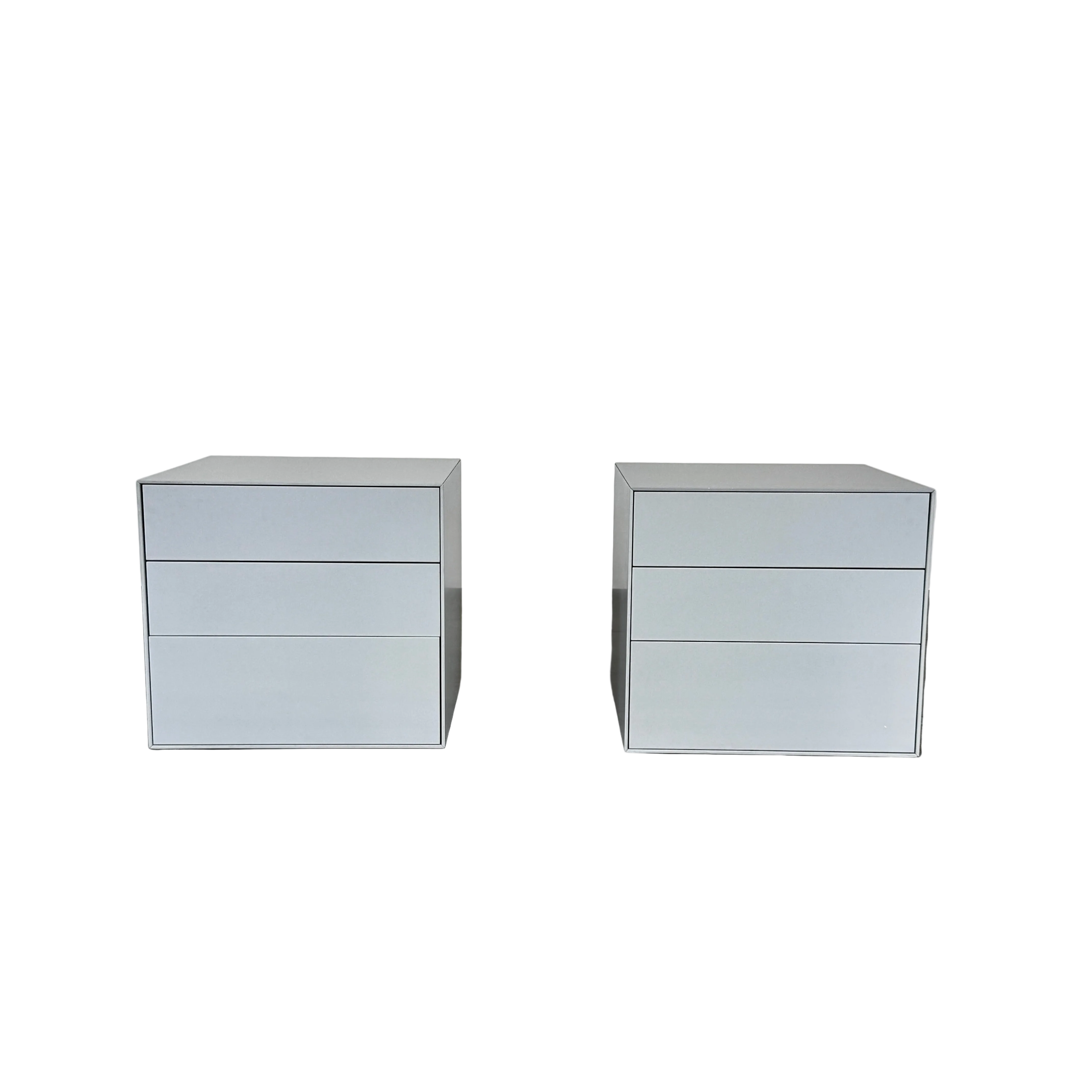 The Treku Lauki collection Side Table (2) by Treku, a gray rectangular side table with three drawers and a minimalist design, is shown against a plain white background.