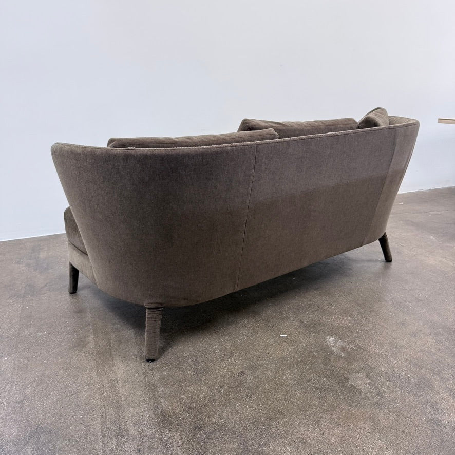 Small gray Maxalto Febo Small Sofa with a curved back, three back cushions, and visible stitched seams.