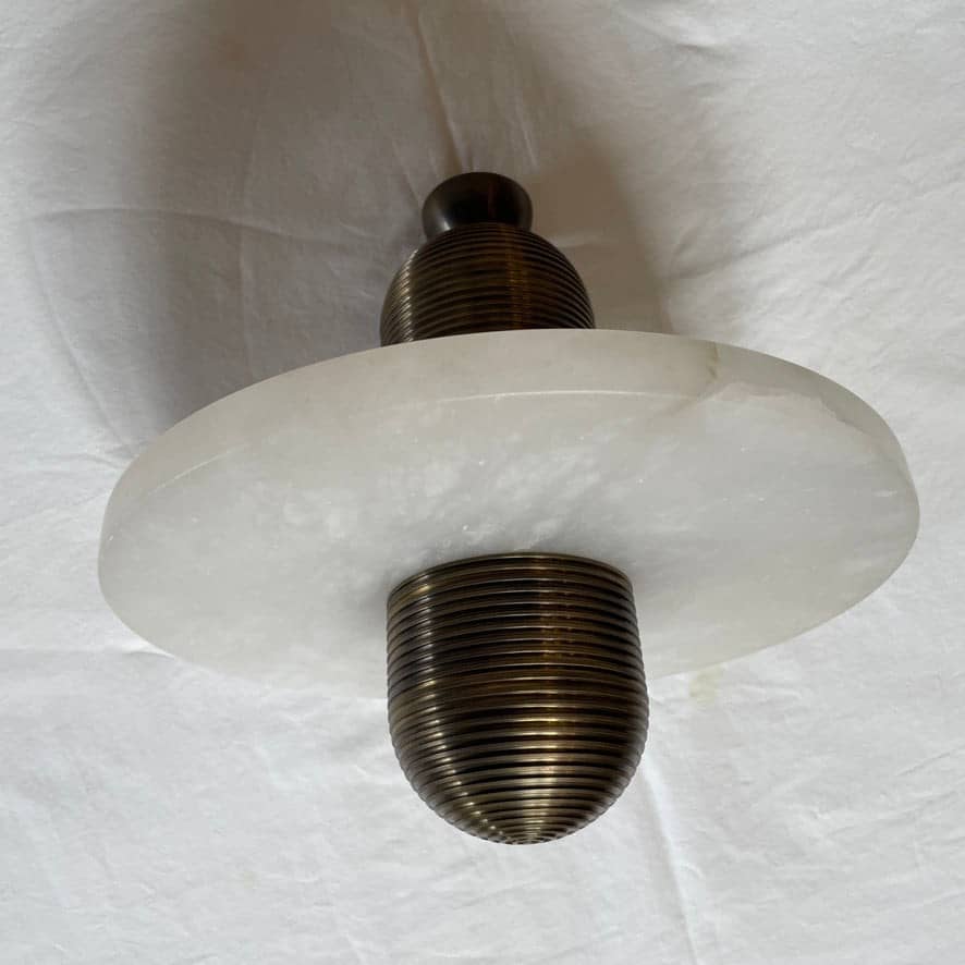 A contemporary Apparatus Studio Median Mono Five pendant ceiling light with three lights hanging from it.