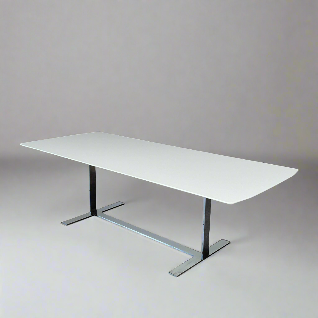A minimalist rectangular B&B Italia Eileen White Dining Table featuring a sophisticated T-shaped metal base on a plain white background.