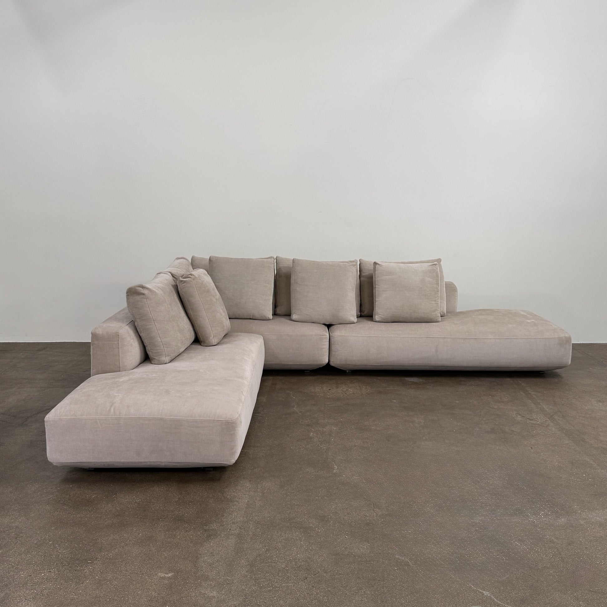 The Zanotta Pianoalto 3 Piece Sectional by Zanotta features light gray brushed cotton blend upholstery and five matching back cushions for ergonomic support, shown against a plain white background.