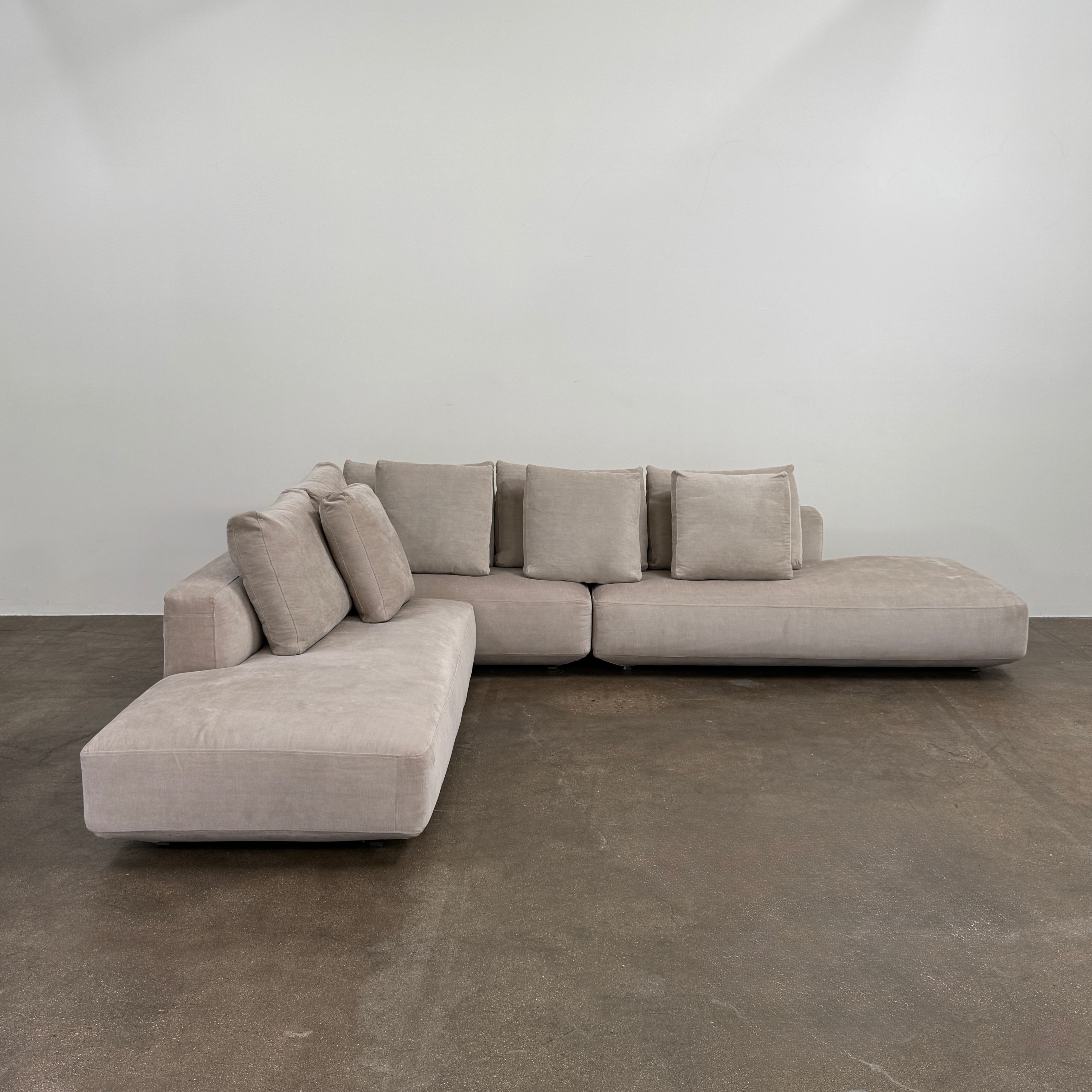 The Zanotta Pianoalto 3 Piece Sectional by Zanotta features light gray brushed cotton blend upholstery and five matching back cushions for ergonomic support, shown against a plain white background.