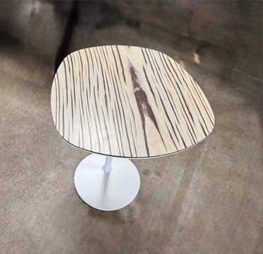 Moroso Bloomy Side Table with an oval, wood-grain top and a single, white pedestal base.
