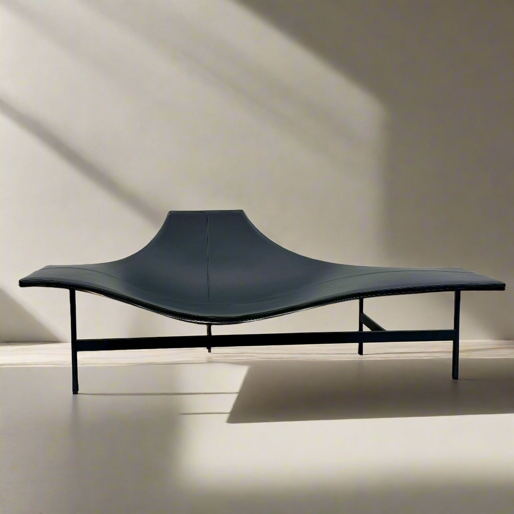 The B&B Italia Terminal 1 Lounge is a modern black bench with Jean-Marie Massaud’s sculpted, wave-like seat, a raised central backrest, and a minimalist black metal frame by B&B Italia.