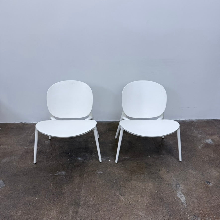 A white Kartell Be Bop lounge chair with a rounded backrest, tapered legs, and a weatherproof design for indoor or outdoor seating.